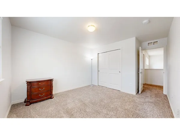 a room with a bed and mirror