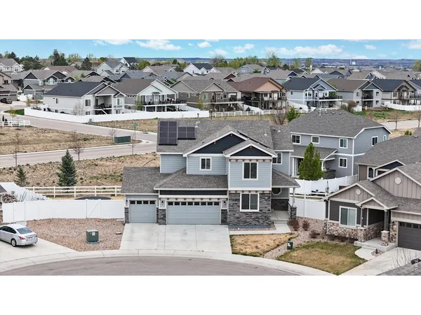 an aerial view of residential houses with a city view