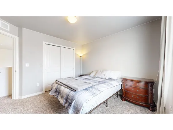 a bedroom with a bed and a mirror