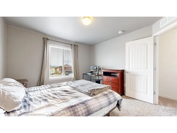 a bedroom with a bed and a window