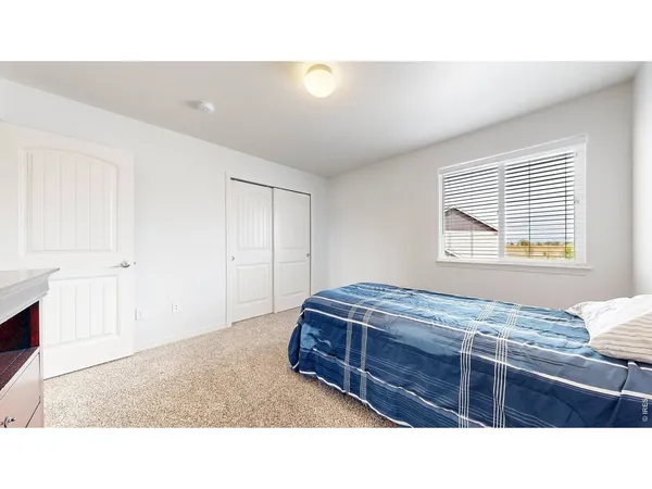 a living room with a bed furniture and a window