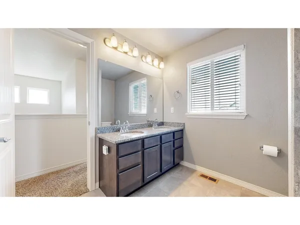 a bathroom with a sink mirror and a bathtub