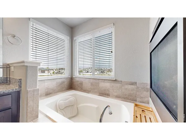 a bathroom with a tub sink and a window