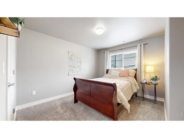 a living room with a bed furniture and a window