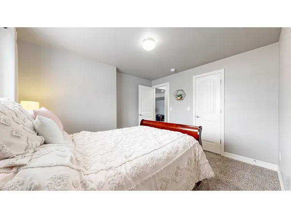 a bedroom with a bed and a painting