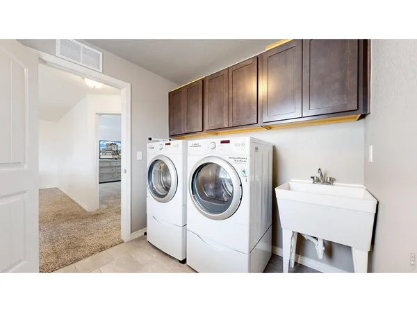 a bathroom with a sink a washer and dryer