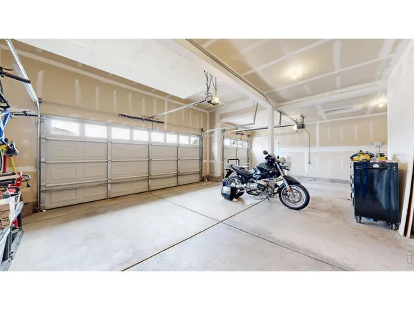 a view of a garage with parked cars