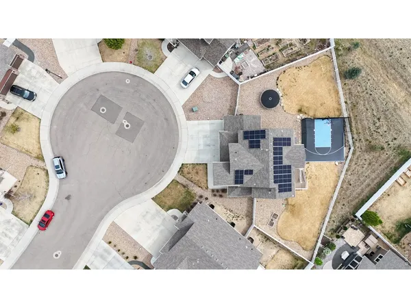 an aerial view of a house with a swimming pool