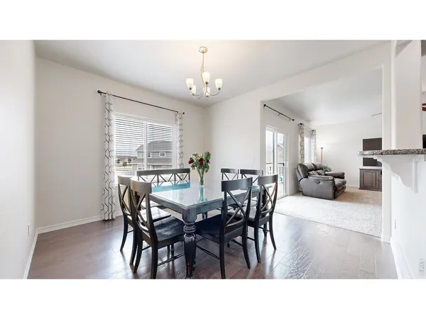 a living room with furniture and a dining table