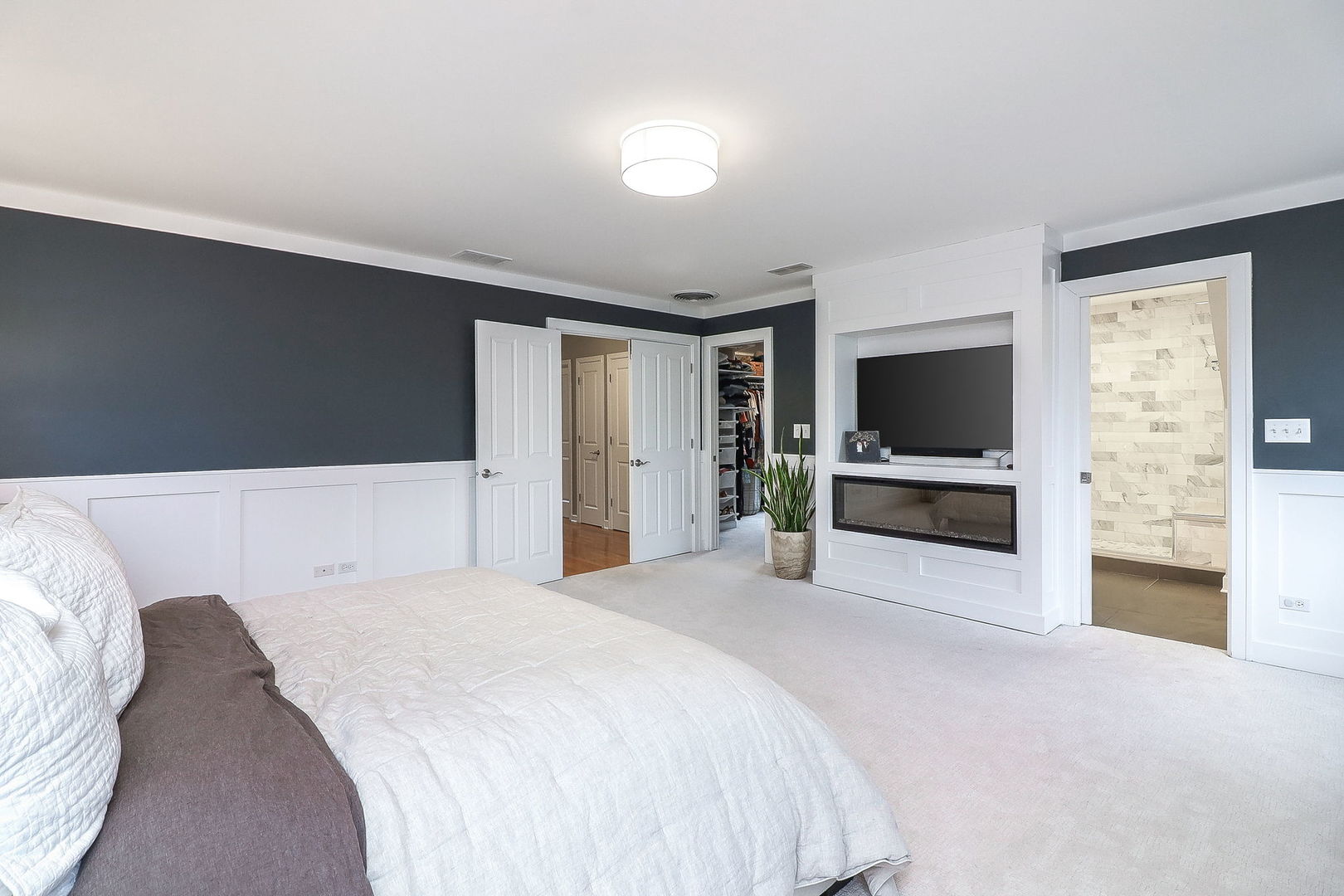 133 South Williston Street Wheaton, IL 60187 - Photo 19 of 43 a spacious bedroom with a bed and a flat screen tv