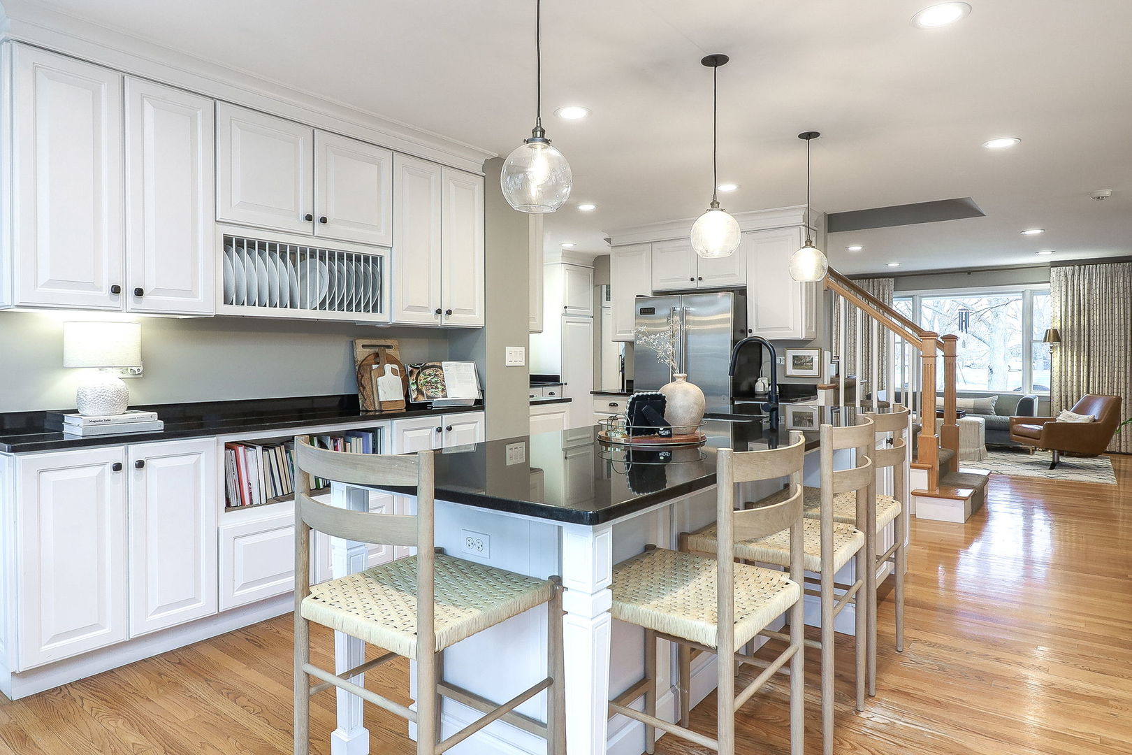 133 South Williston Street Wheaton, IL 60187 - Photo 2 of 43 a kitchen with stainless steel appliances kitchen island granite countertop a stove a sink a dining table and chairs with wooden floor