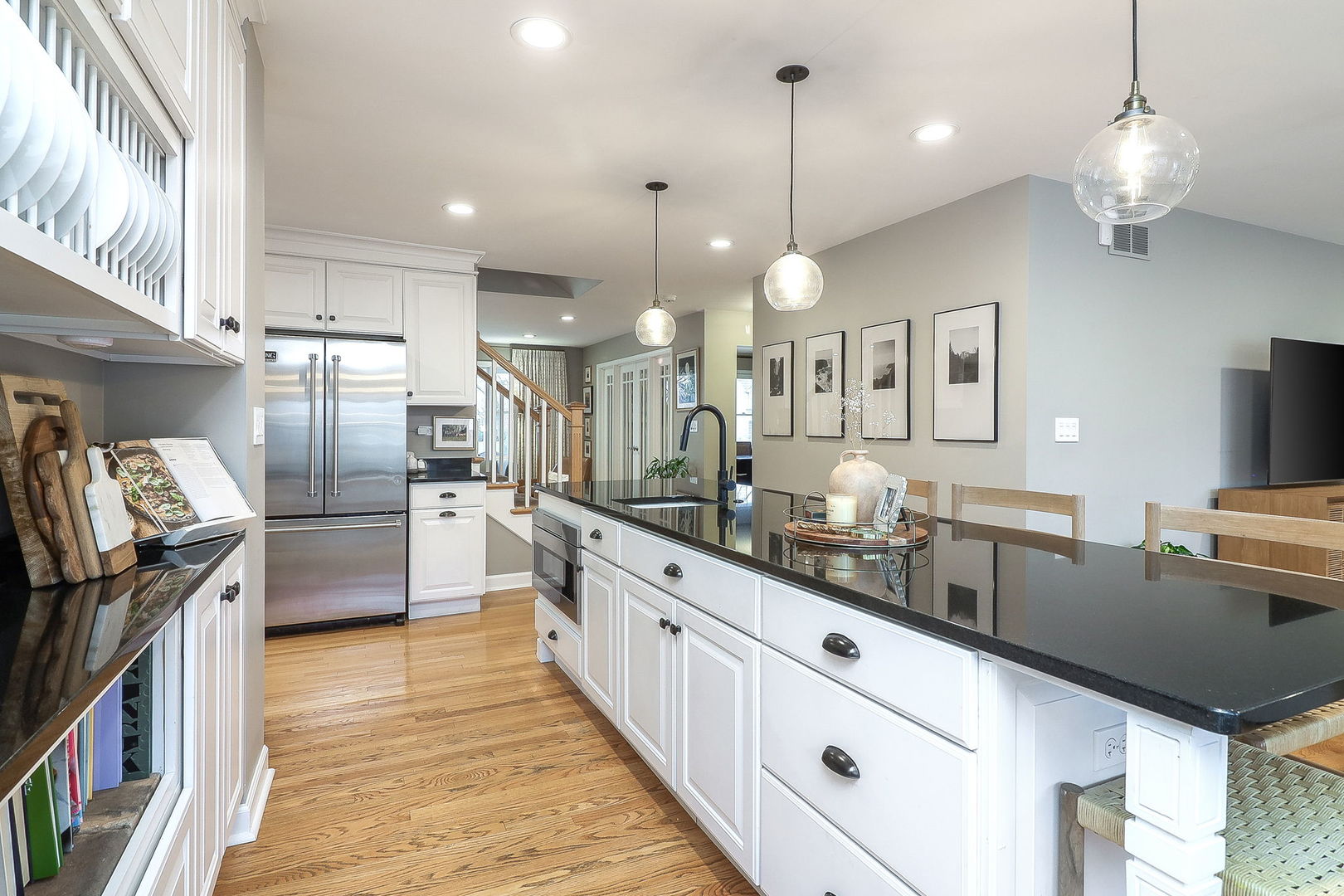 133 South Williston Street Wheaton, IL 60187 - Photo 5 of 43 a large kitchen with granite countertop a large kitchen island white cabinets and stainless steel appliances
