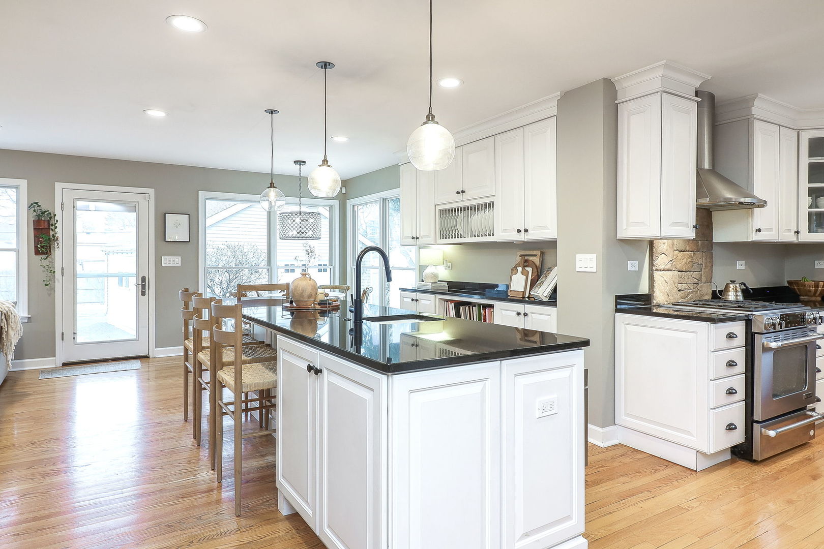 133 South Williston Street Wheaton, IL 60187 - Photo 7 of 43 a kitchen with stainless steel appliances granite countertop a sink a stove and a wooden floor