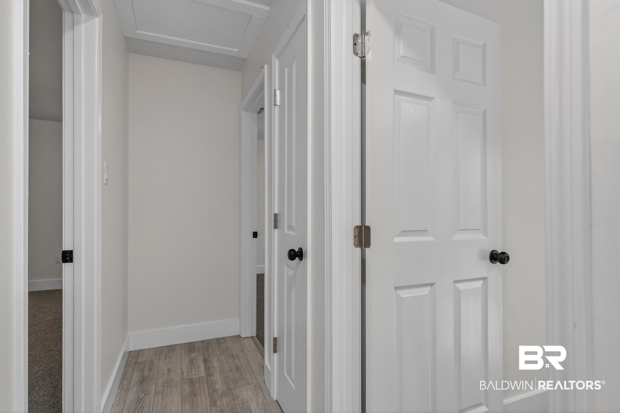 10650 Old Pascagoula Road Theodore, AL 36582 - Photo 39 of 77 Hallway featuring light wood-style flooring and baseboards