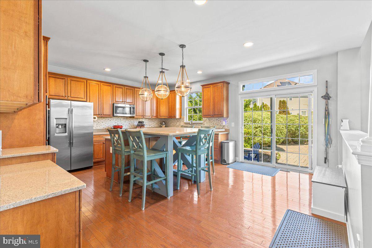 2650 Valhalla Road Vineland, NJ 08361 - Photo 10 of 49 a dining room with stainless steel appliances granite countertop a refrigerator a stove top oven a dining table and chairs with wooden floor