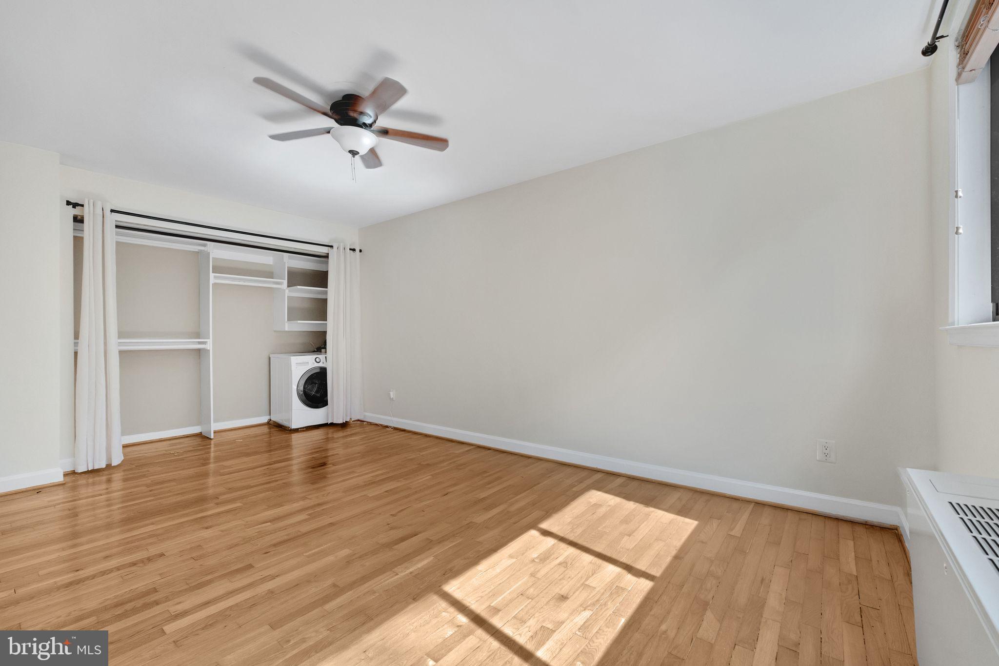 2725 39th Street Northwest, Unit 307 Washington, DC 20007 - Photo 15 of 18 wooden floor in an empty room with a window
