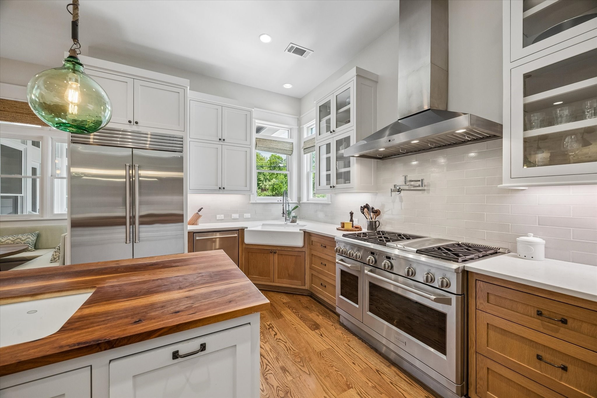 1101 Omar Street Houston, TX 77009 - Photo 14 of 46 Thoughtfully designed for both beauty and function, the kitchen features a deep farmhouse sink, premium cooktop, and double ovens ideal for effortless entertaining and elevated everyday living.