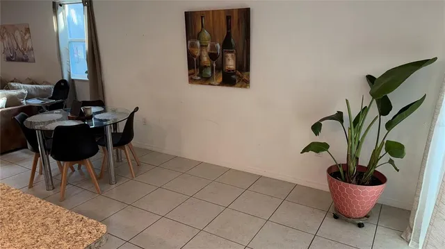 a dining room with furniture and potted plant