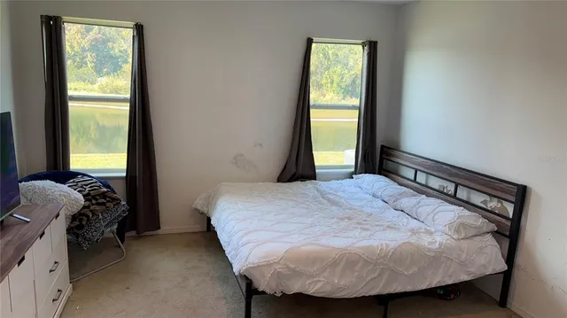 a bedroom with a bed and a window