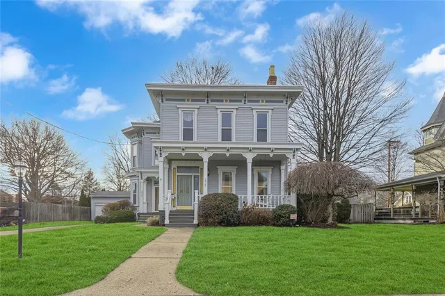 a front view of a house with a garden