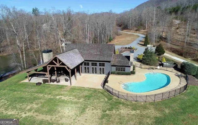 a backyard of a house with a yard and outdoor seating