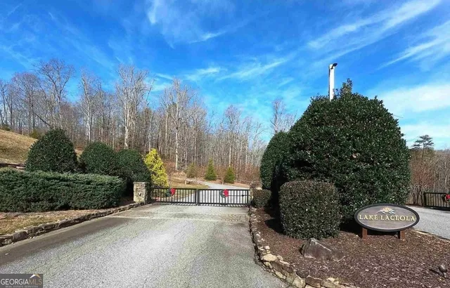 a view of a house with a mountain and a forest