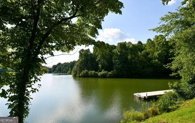 a view of a lake with a yard and outdoor seating