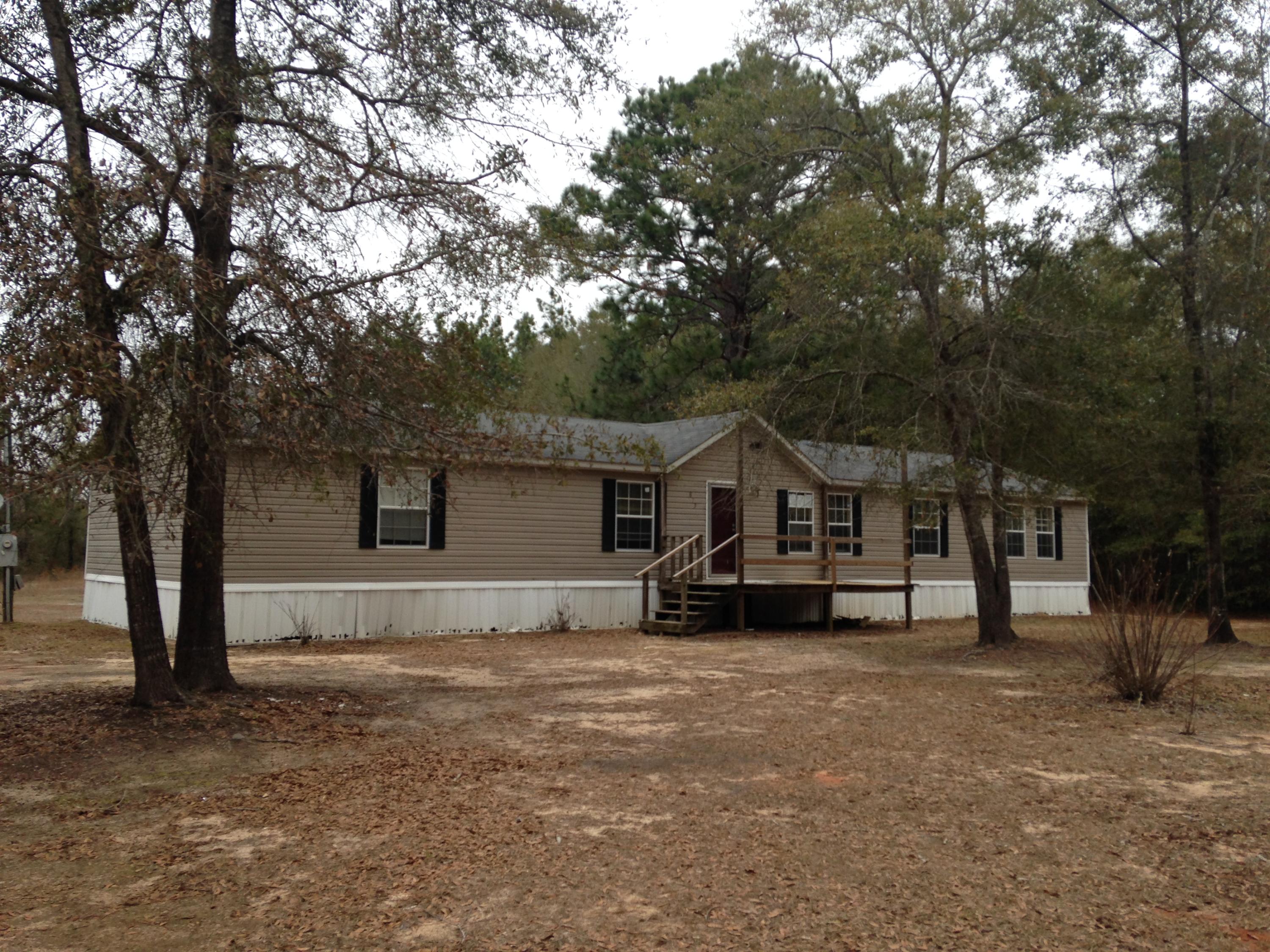 873 Lighthouse Church Road Holt, FL 32564 - Photo 1 of 18 a house that has a tree in front of it