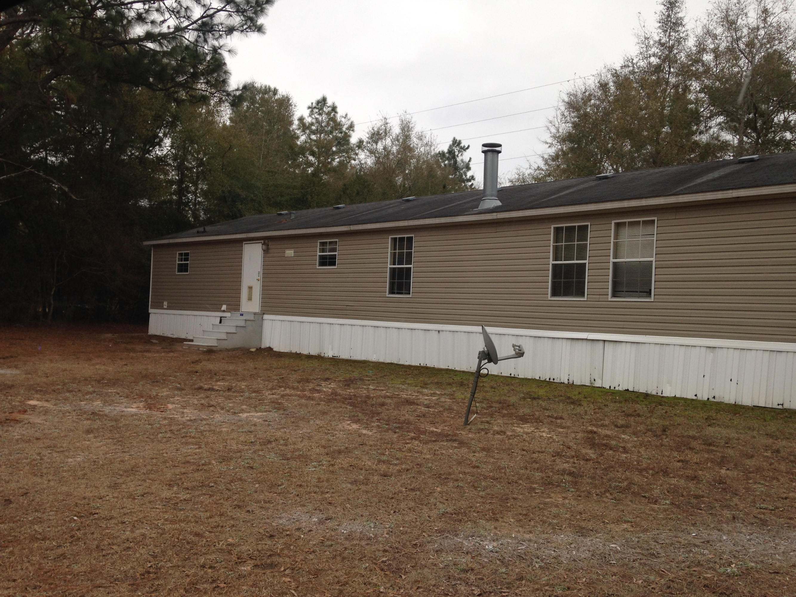 873 Lighthouse Church Road Holt, FL 32564 - Photo 17 of 18 a backyard of a house with lots of green space