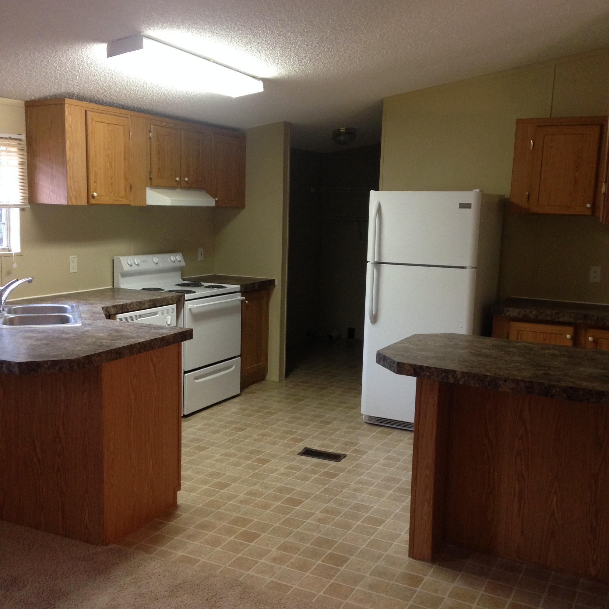 873 Lighthouse Church Road Holt, FL 32564 - Photo 4 of 18 a kitchen with kitchen island a stove a refrigerator and a sink