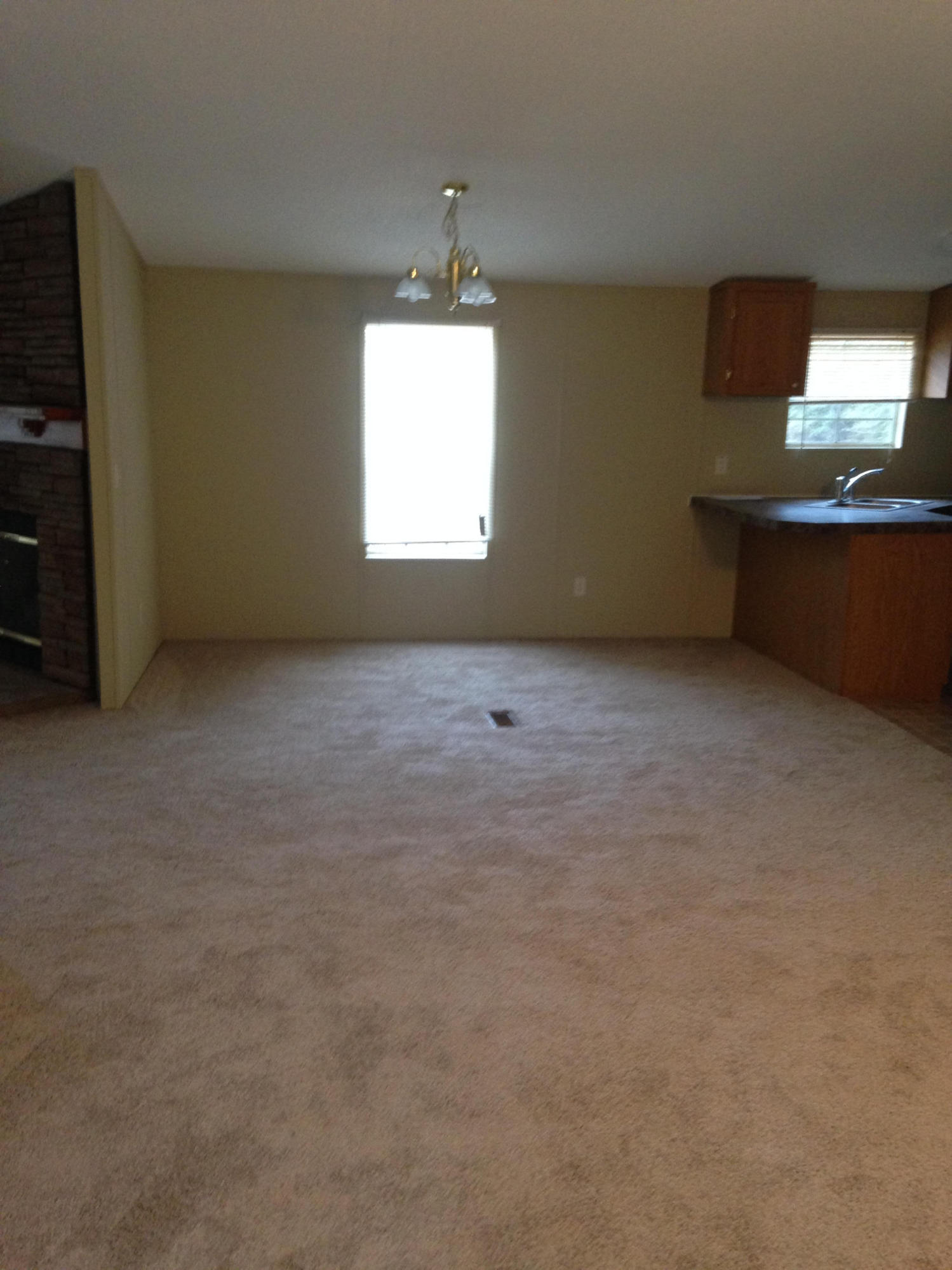 873 Lighthouse Church Road Holt, FL 32564 - Photo 5 of 18 an empty room with a fireplace and windows