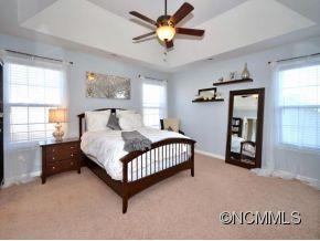 306 Lumber River Road Fletcher, NC 28732 - Photo 7 of 15 a bedroom with a bed and a chandelier