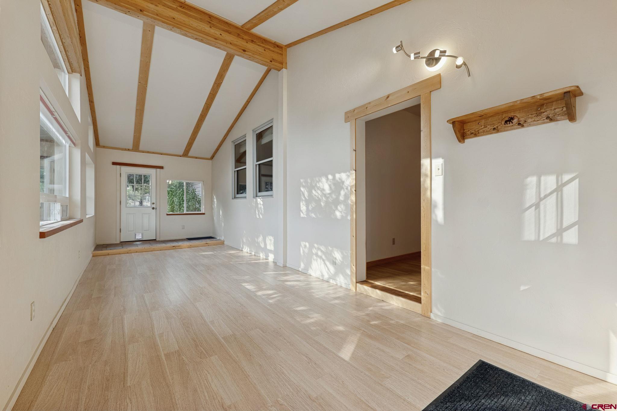 481 Far View Road Durango, CO 81303 - Photo 20 of 45 a view of a big room with wooden floor and windows