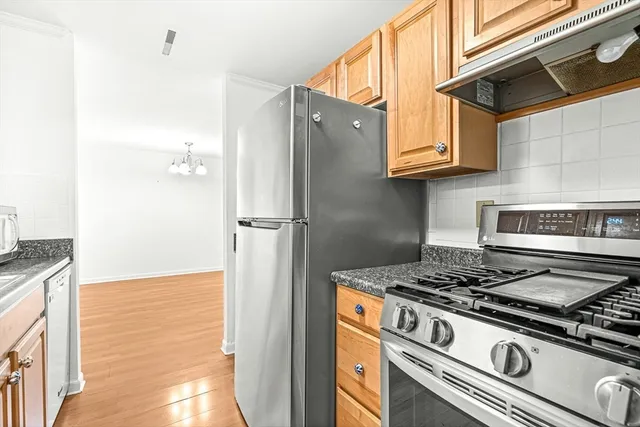 a kitchen with a stove and a refrigerator
