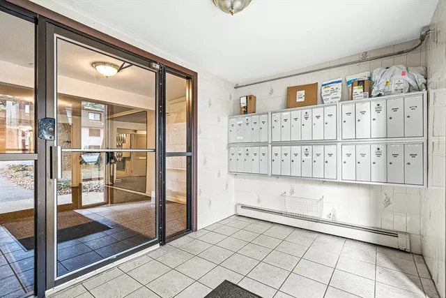 a view of a livingroom with wooden floor and windows
