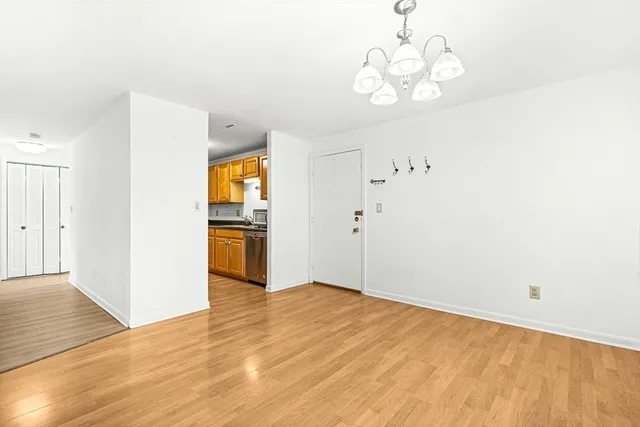 a view of a kitchen with wooden floor and windows