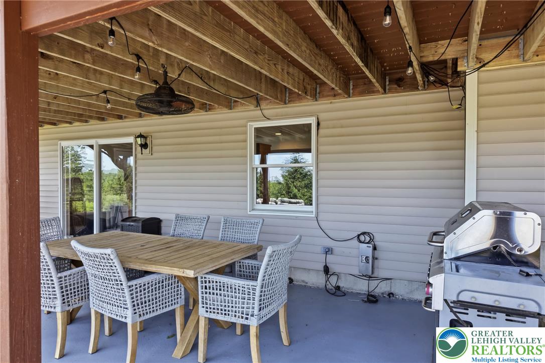 115 West Butternut Road Hellertown, PA 18055 - Photo 75 of 97 An inviting covered patio, perfect for outdoor dining and relaxation, with picturesque views of the surrounding natural landscape.