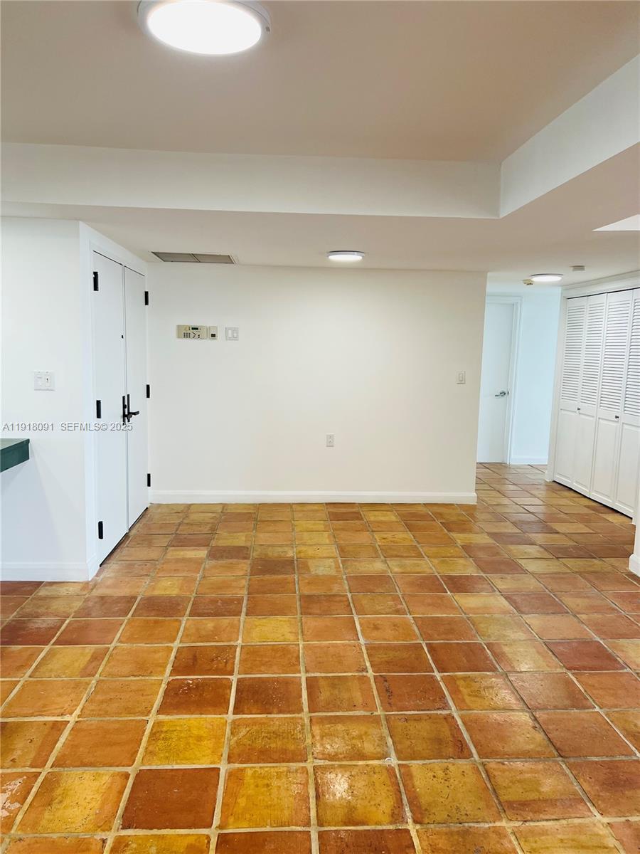 1 Grove Isle Drive, Unit A405 Miami, FL 33133 - Photo 14 of 21 a view of a room with white checkered floor