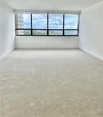 a spacious bathroom with a granite countertop sink mirror and cabinets