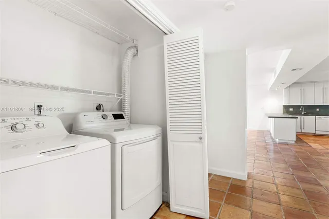 a view of storage and utility room with washer and dryer