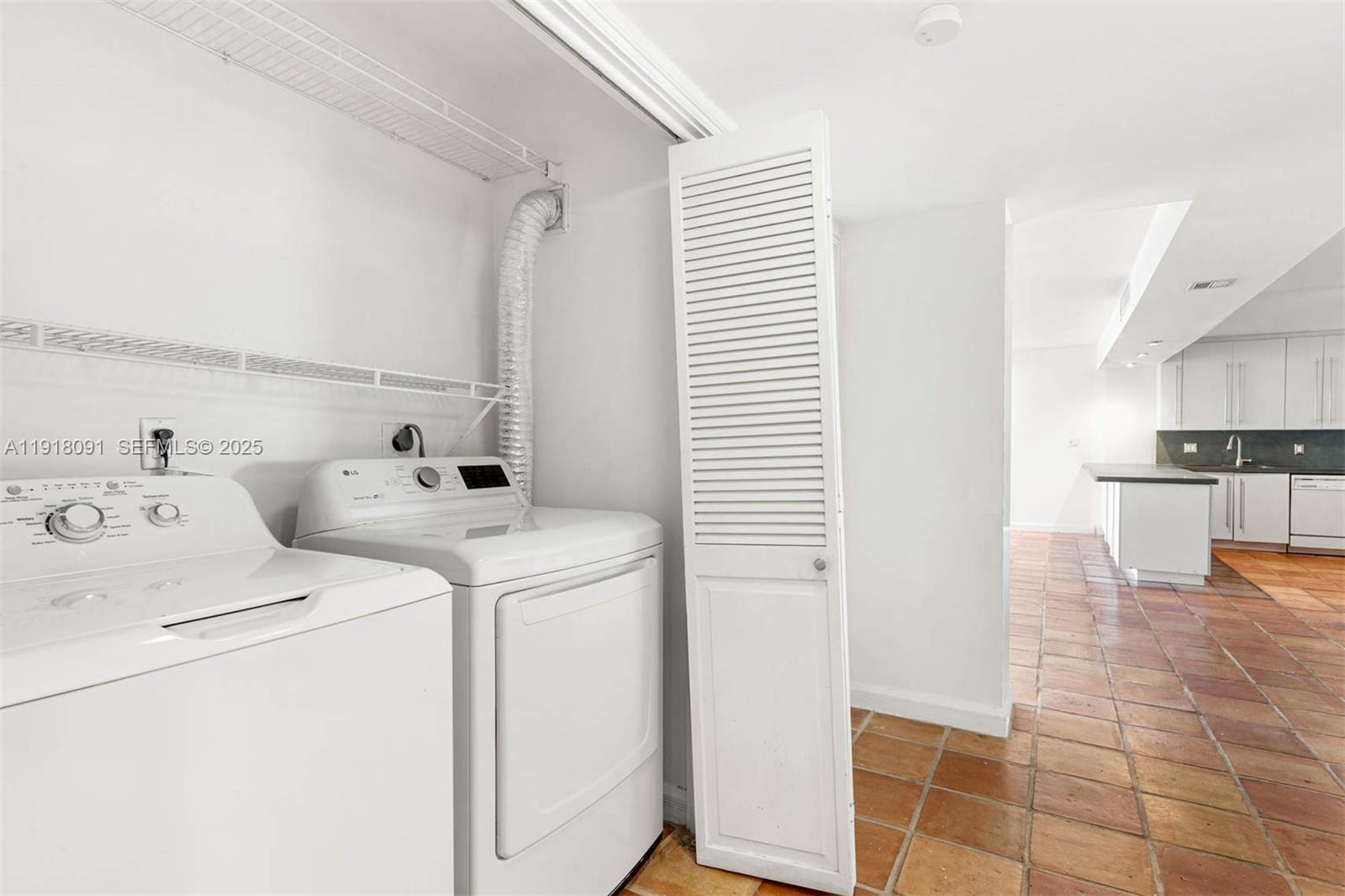 1 Grove Isle Drive, Unit A405 Miami, FL 33133 - Photo 5 of 21 a view of storage and utility room with washer and dryer