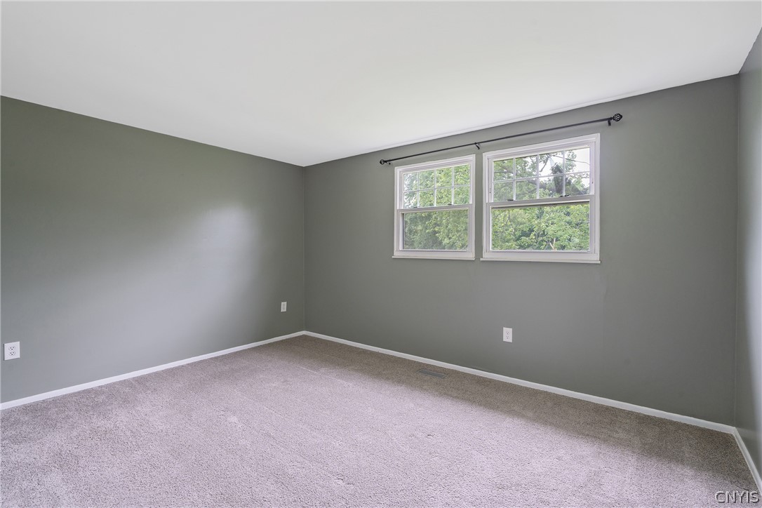 114 Saltwell Road Salina, NY 13090 - Photo 21 of 27 The third bedroom serves as the primary. High-set windows give privacy without a cavernous feel.