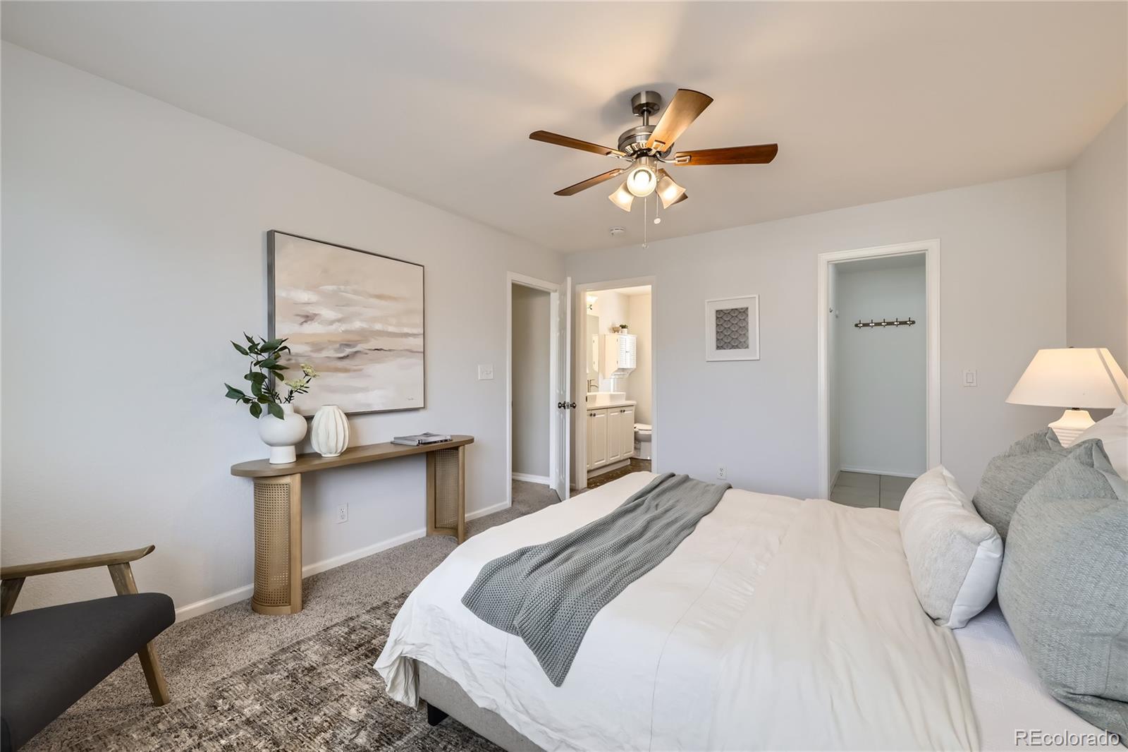 1552 Spring Water Place Highlands Ranch, CO 80129 - Photo 12 of 28 a bedroom with a bed and a chandelier