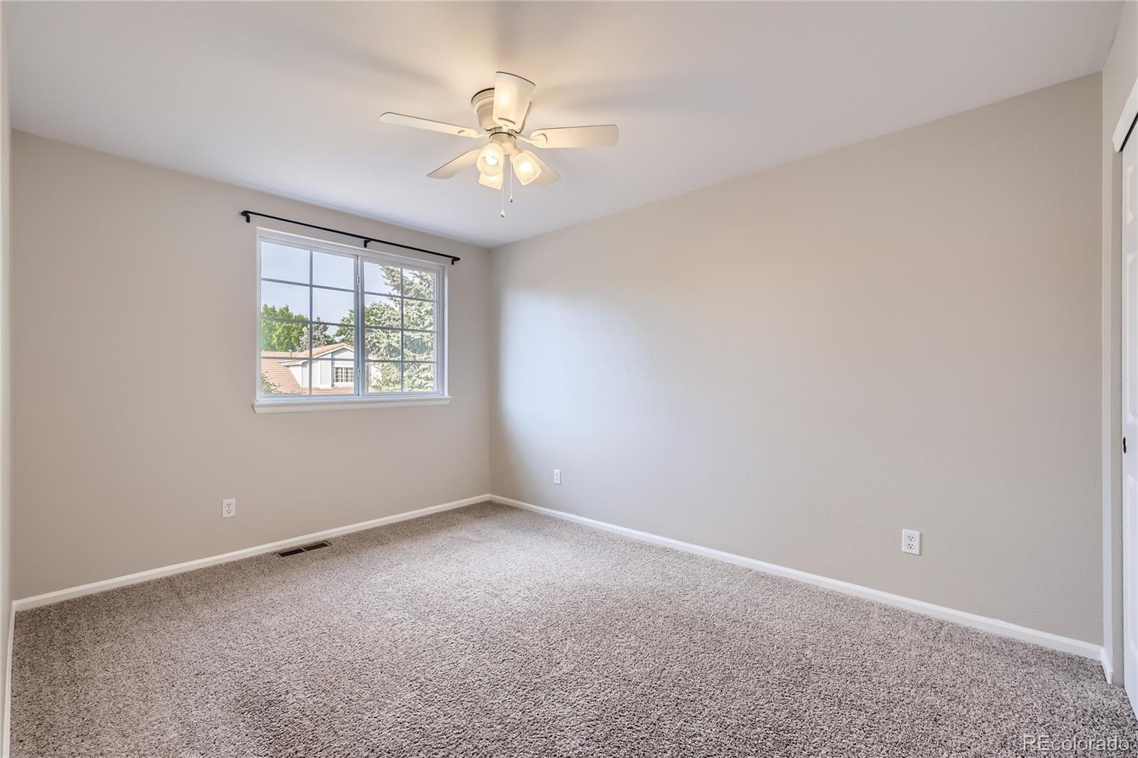 1552 Spring Water Place Highlands Ranch, CO 80129 - Photo 16 of 28 an empty room with windows and fan