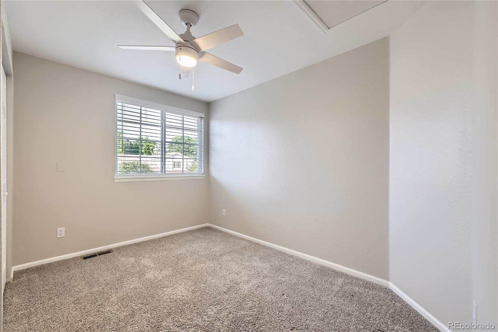 1552 Spring Water Place Highlands Ranch, CO 80129 - Photo 18 of 28 an empty room with a window and a fan