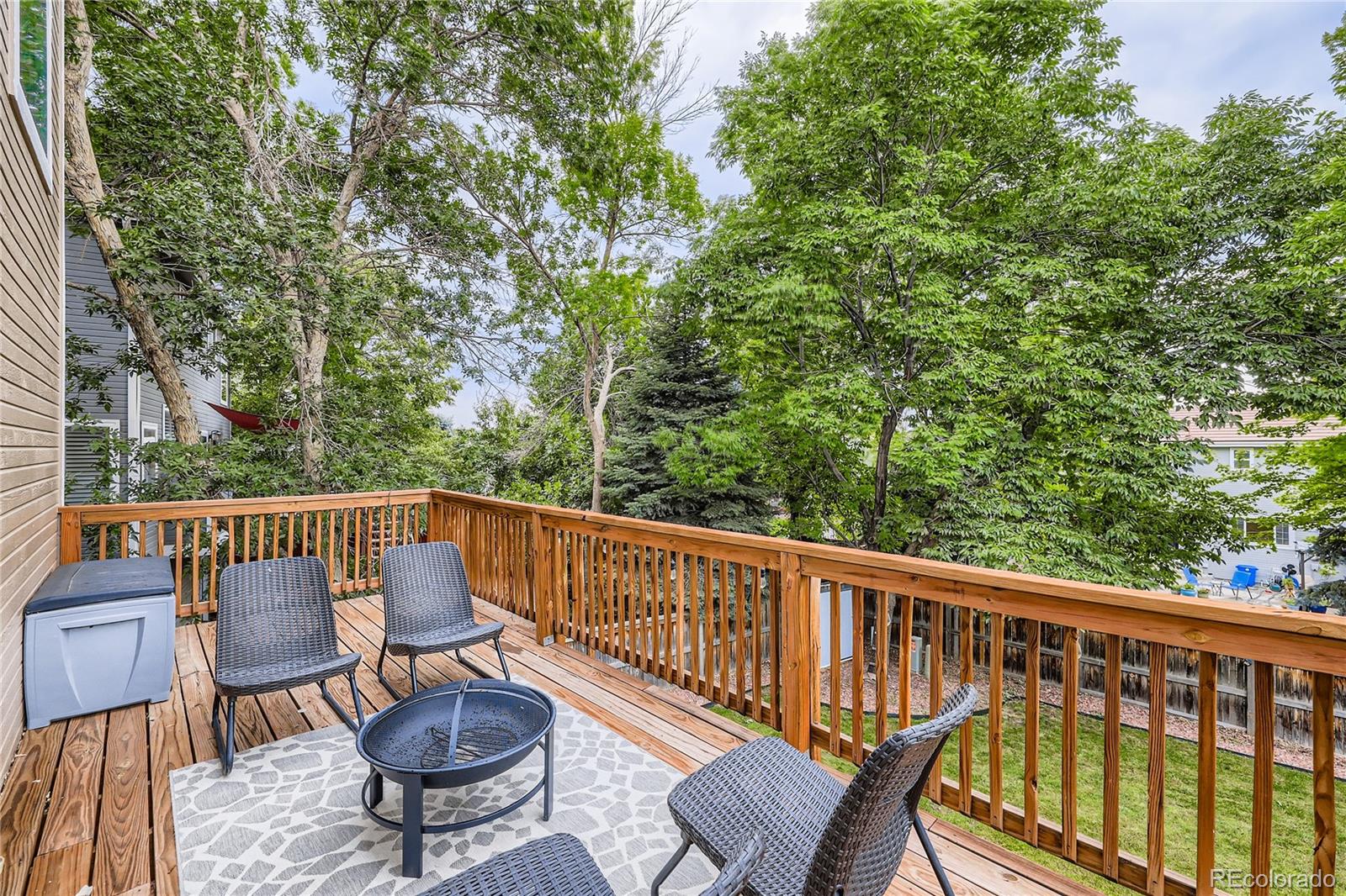 1552 Spring Water Place Highlands Ranch, CO 80129 - Photo 25 of 28 a view of balcony with wooden floor and outdoor seating