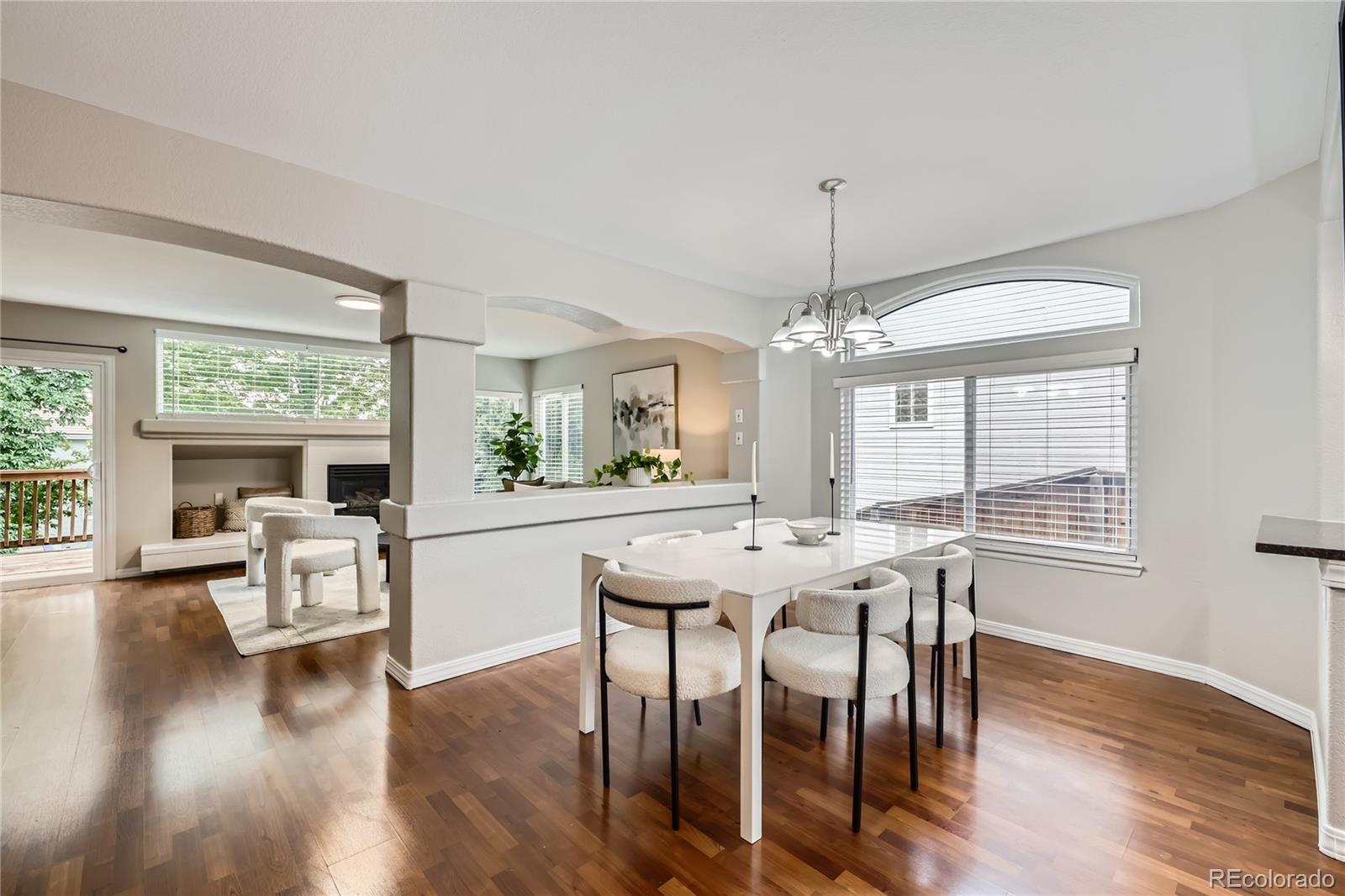1552 Spring Water Place Highlands Ranch, CO 80129 - Photo 5 of 28 a view of a dining room with furniture window and wooden floor