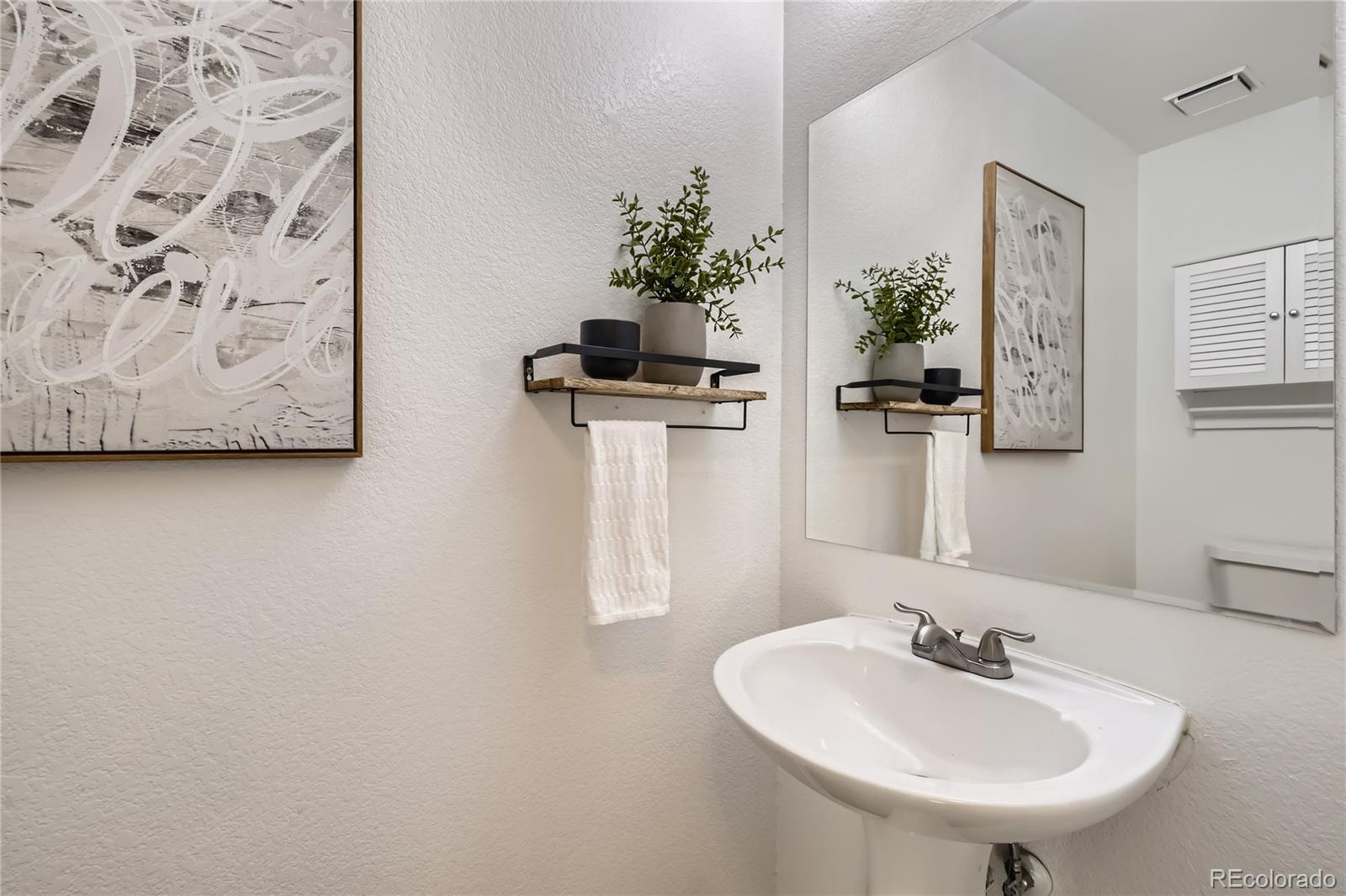 1552 Spring Water Place Highlands Ranch, CO 80129 - Photo 9 of 28 a bathroom with a sink and a mirror