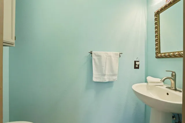 a kitchen with a sink window and cabinets