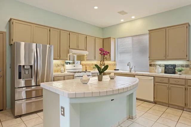 a kitchen with stainless steel appliances a stove sink and cabinets